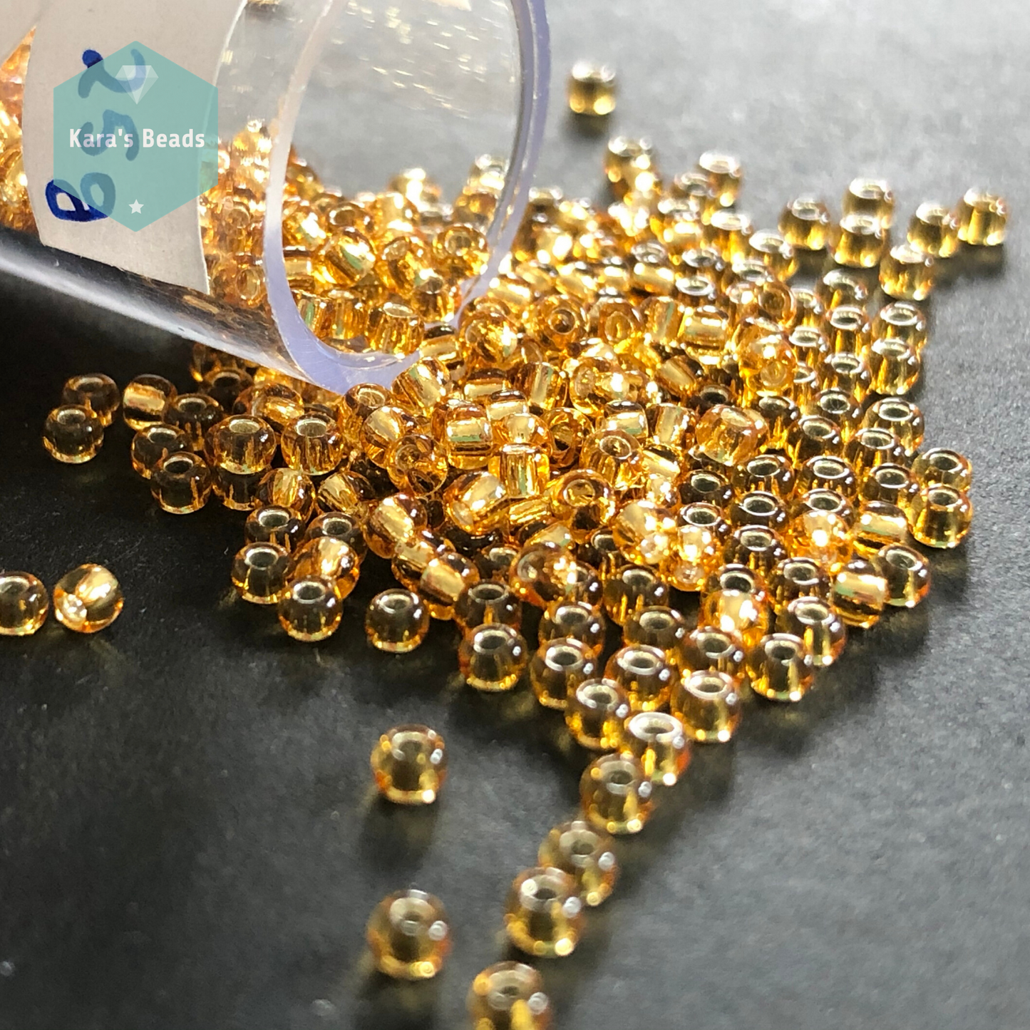 25g Tube 11/0 Toho TR11-22B Silver Lined Medium Topaz