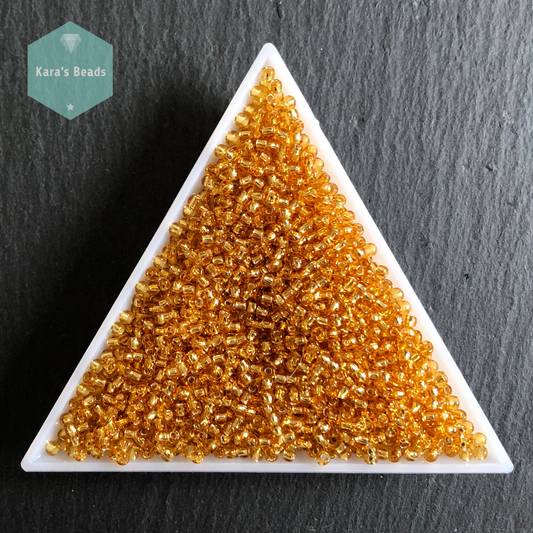 25g Tube 11/0 Toho TR11-22B Silver Lined Medium Topaz